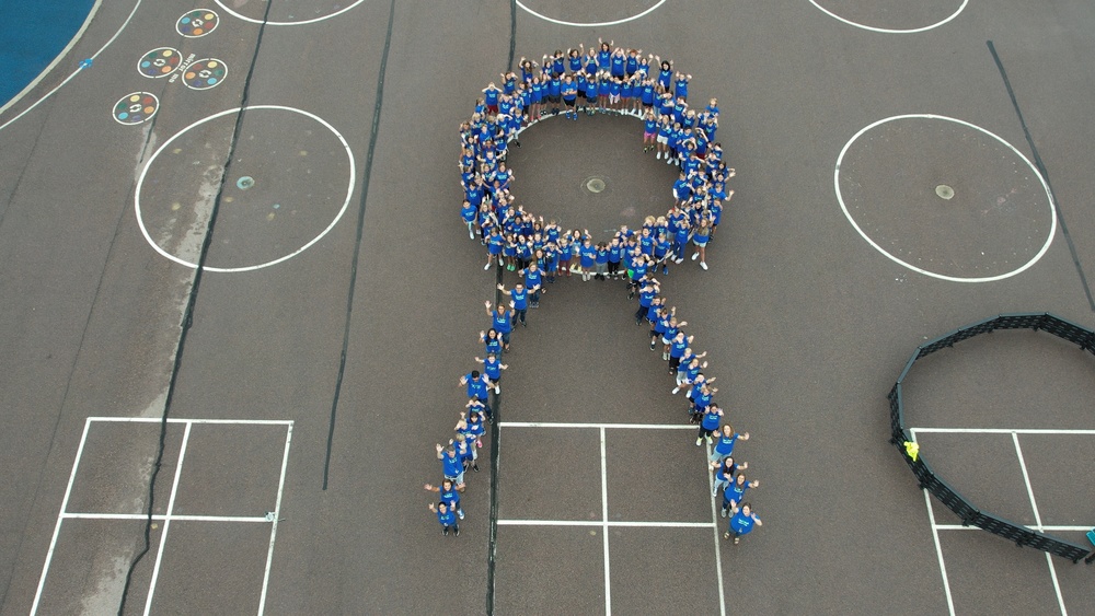 Sonia Sotomayor fifth grade students circle up to create a ribbon