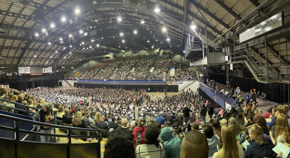 several hundred orchestra students filling the Sioux Falls arena floor 