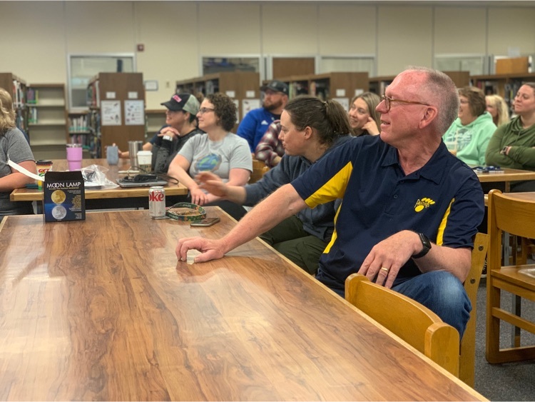 Teachers sitting at tables in a library