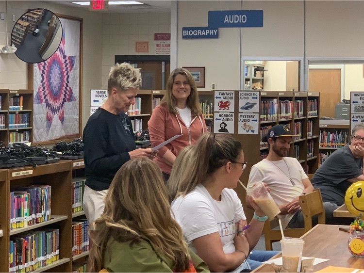 Teachers sitting at tables in a library