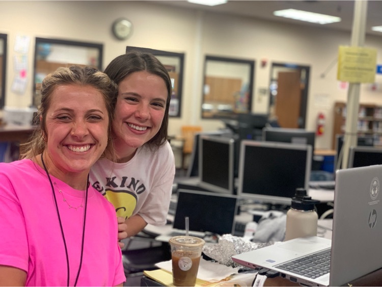 Teachers sitting at tables in a library