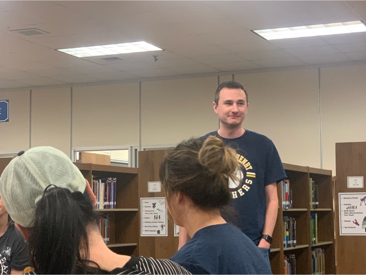 Teacher standing in a library