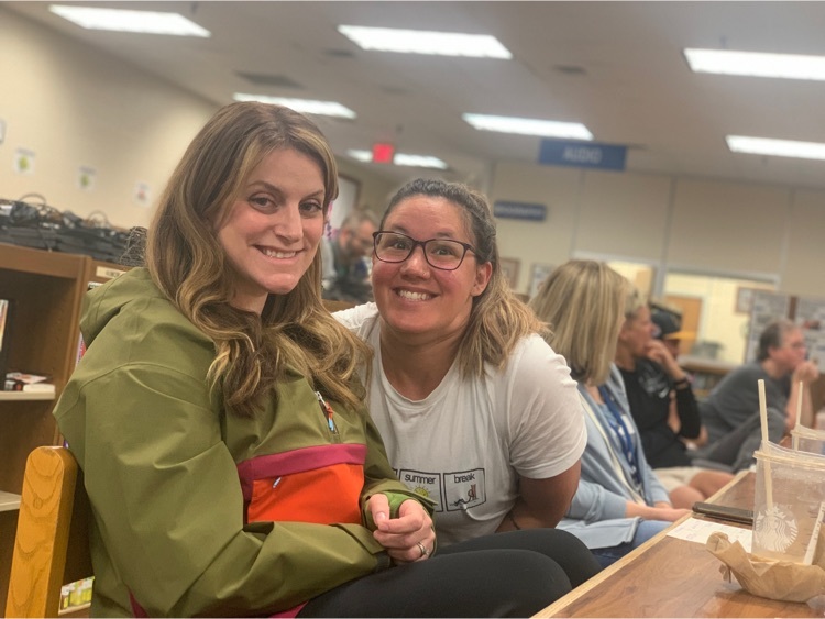 Teachers sitting at tables in a library